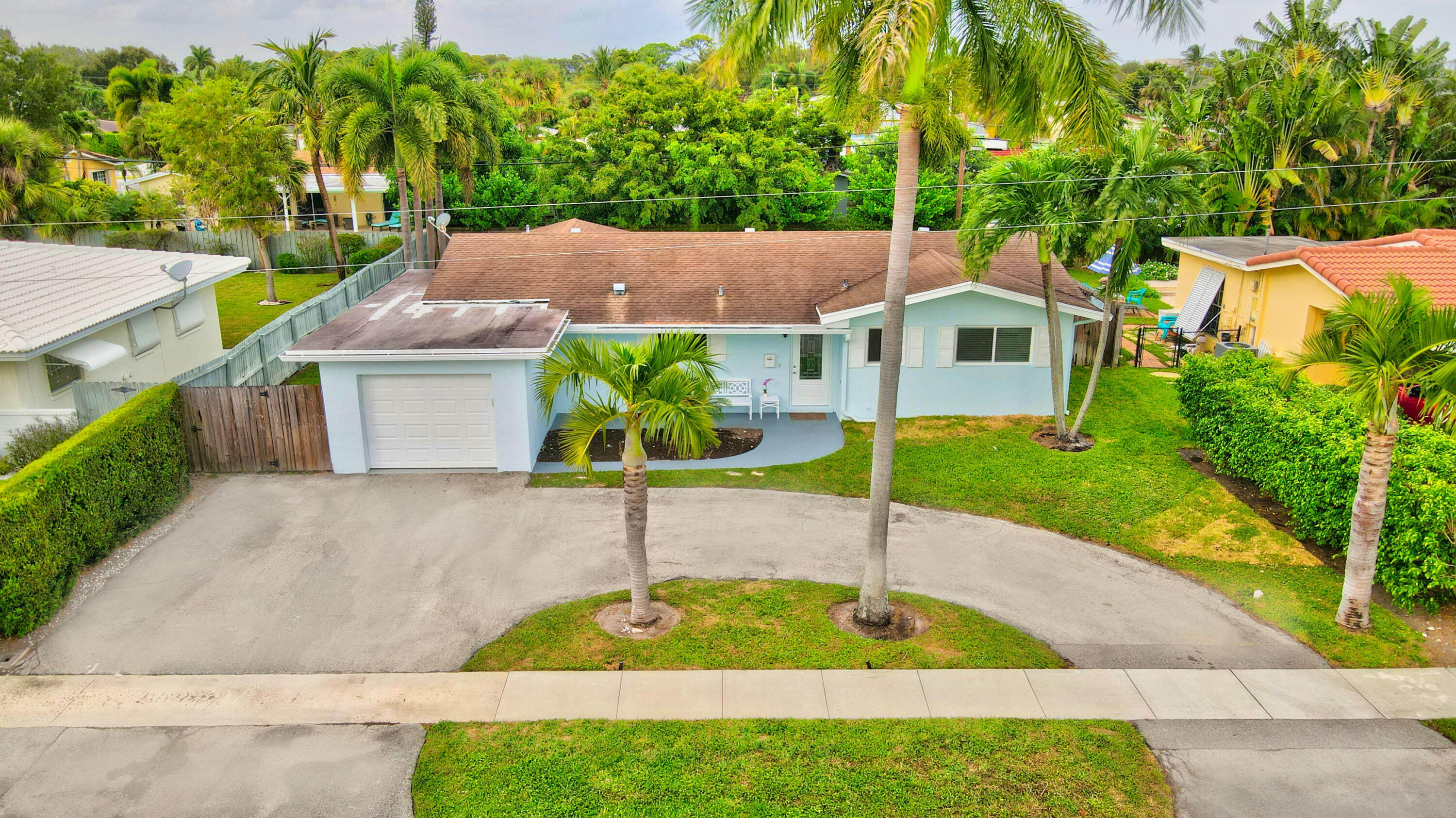 1133 Southwest 7th Street Boca Raton, FL 33486 - Photo 18 of 20 a view of a house with a yard and potted plants