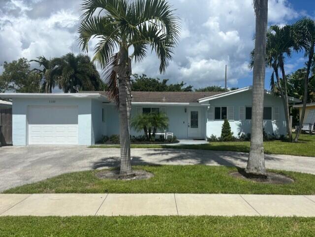 1133 Southwest 7th Street Boca Raton, FL 33486 - Photo 2 of 20 a front view of a house with garden