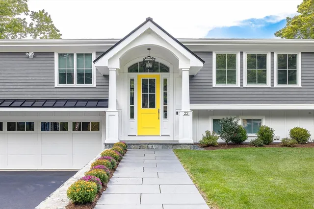 a view of a brick house with potted plants and a large window