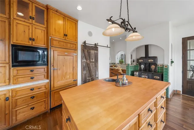 a bedroom with a bed and a flat tv screen next to a large window