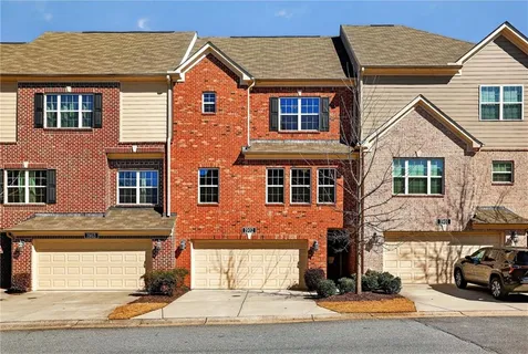 a front view of a house with a parking area