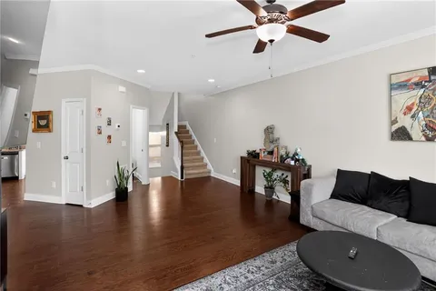 a living room with furniture and a wooden floor