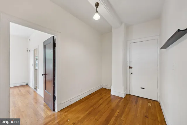 a view of a room with wooden floor