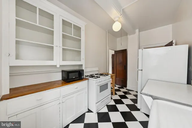 a kitchen with a refrigerator a sink and cabinets