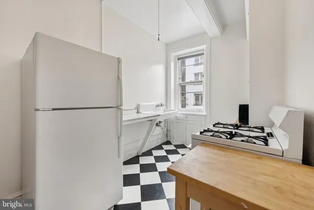a kitchen with stainless steel appliances a refrigerator and a stove top oven