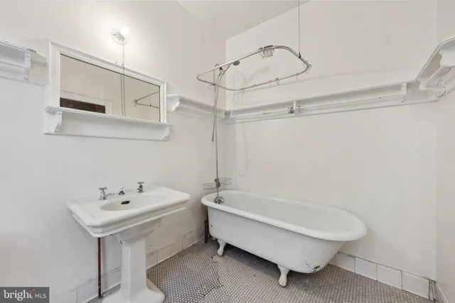 a bathroom with a sink a toilet and bathtub