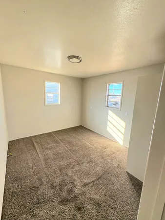 a view of an empty room and a window