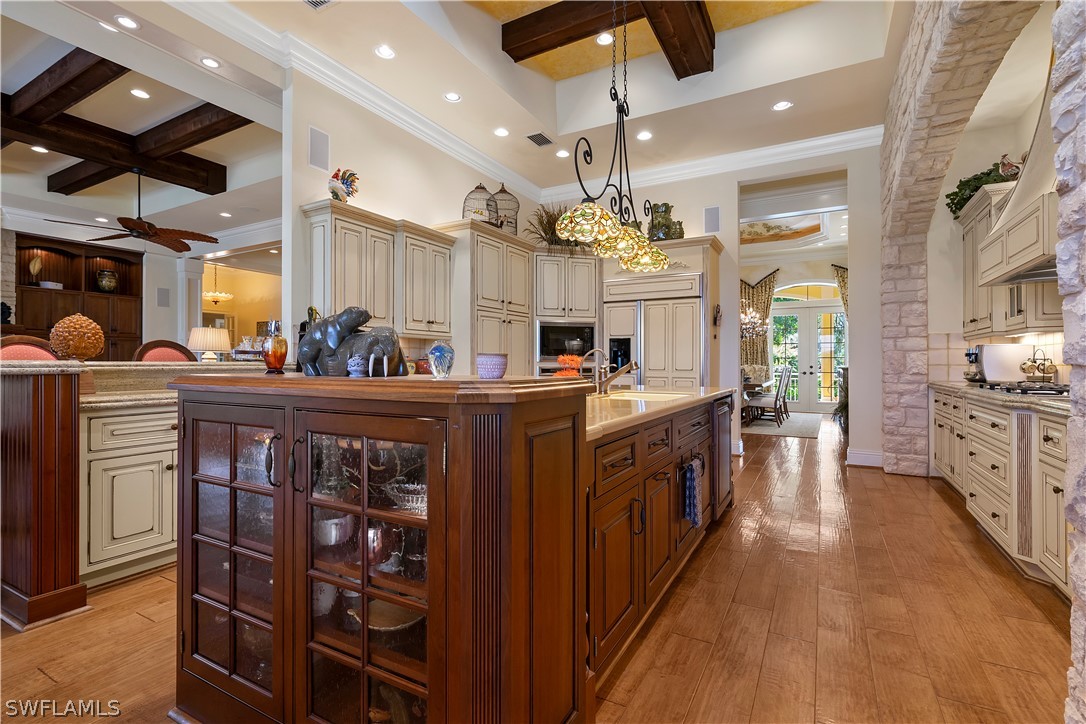 1980 Fort Denaud Road Fort Denaud, FL 33935 - Photo 11 of 35 a large kitchen with stainless steel appliances kitchen island granite countertop a large stove a sink dishwasher and white cabinets with wooden floor