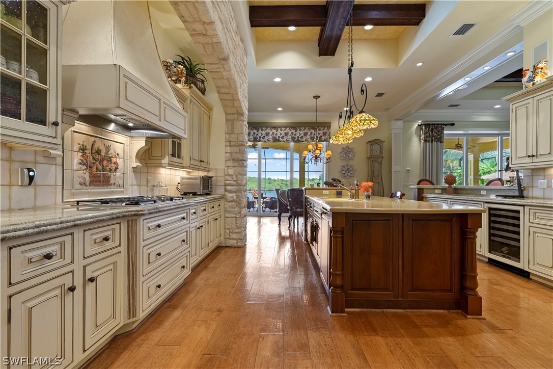 1980 Fort Denaud Road Fort Denaud, FL 33935 - Photo 12 of 35 a kitchen with stainless steel appliances kitchen island granite countertop a stove a sink dishwasher and white cabinets with wooden floor