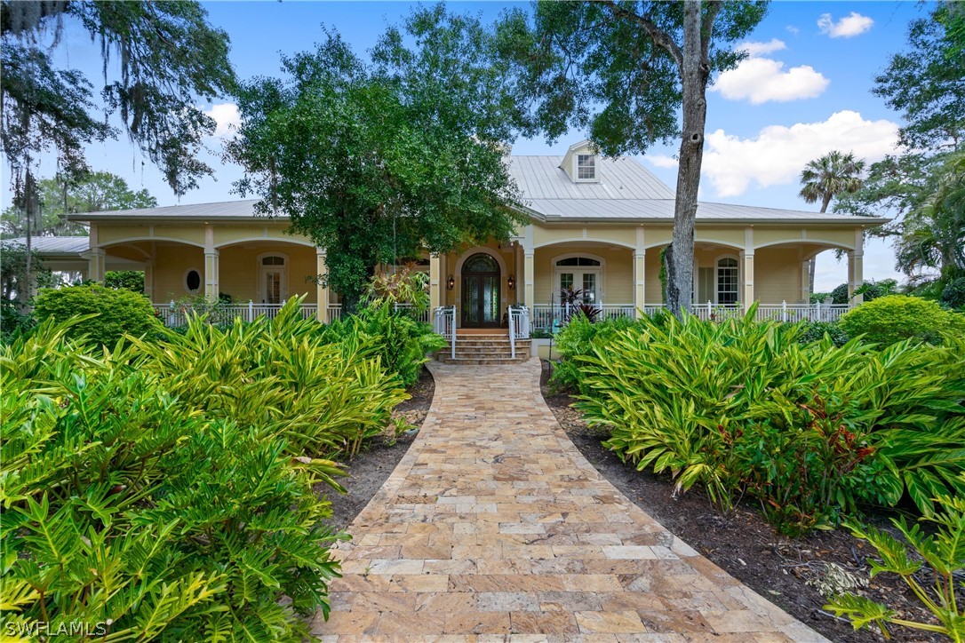 1980 Fort Denaud Road Fort Denaud, FL 33935 - Photo 2 of 35 a front view of a house with yard and green space