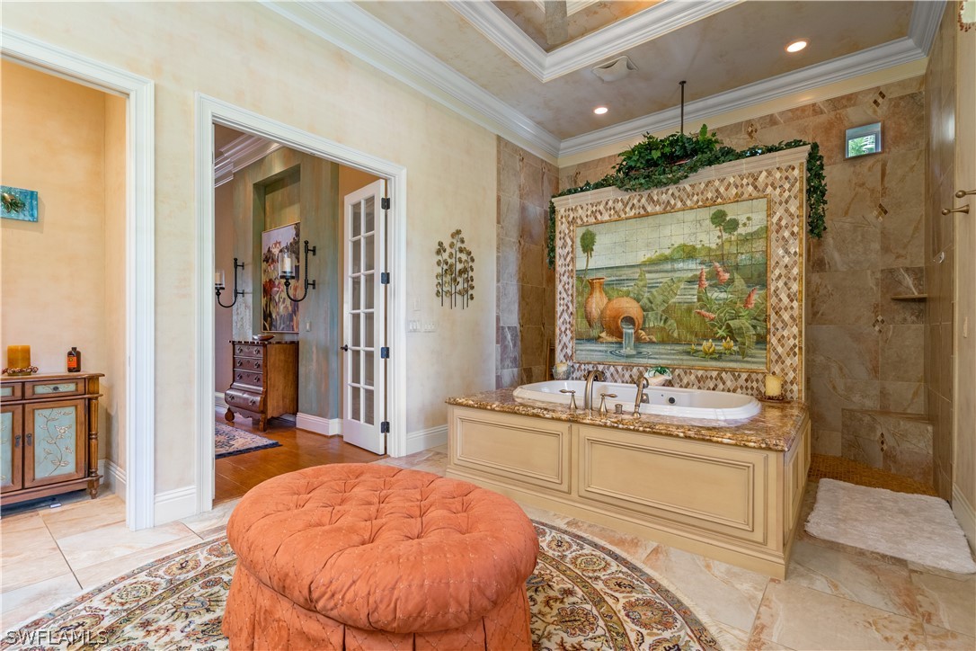 1980 Fort Denaud Road Fort Denaud, FL 33935 - Photo 23 of 35 a spacious bathroom with a double vanity sink a mirror and a bathtub