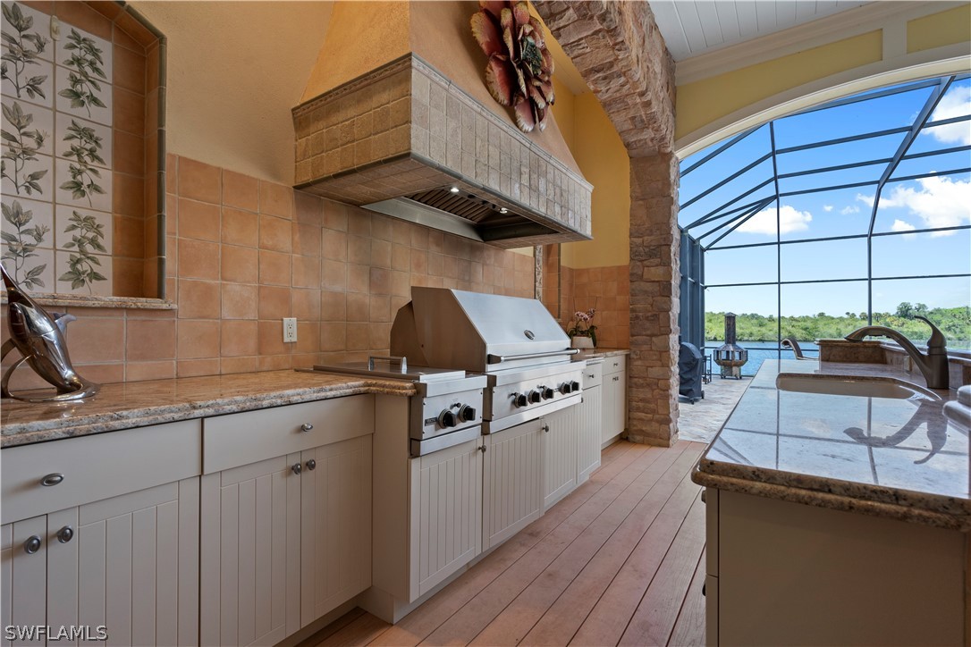 1980 Fort Denaud Road Fort Denaud, FL 33935 - Photo 25 of 35 a kitchen with stainless steel appliances granite countertop a sink a stove and cabinets