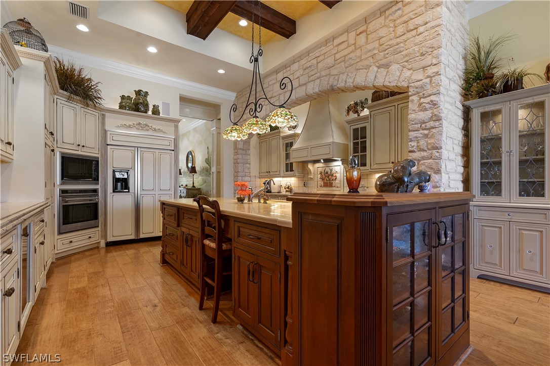 1980 Fort Denaud Road Fort Denaud, FL 33935 - Photo 10 of 35 a kitchen with stainless steel appliances granite countertop a refrigerator a sink dishwasher a stove and a dining table with wooden floor