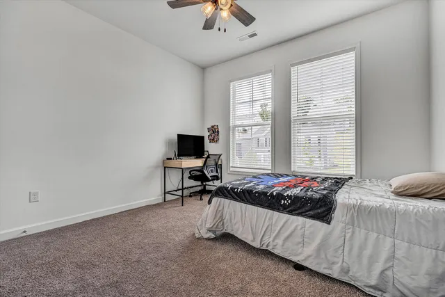 a bathroom with a sink a toilet a mirror and shower