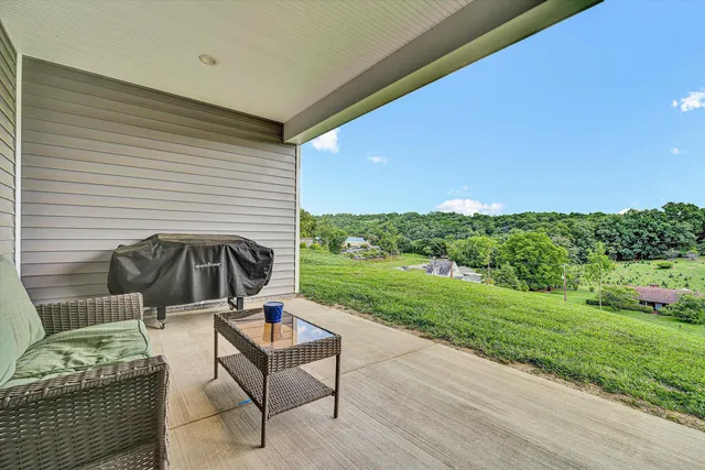 a view of a green field with sitting area