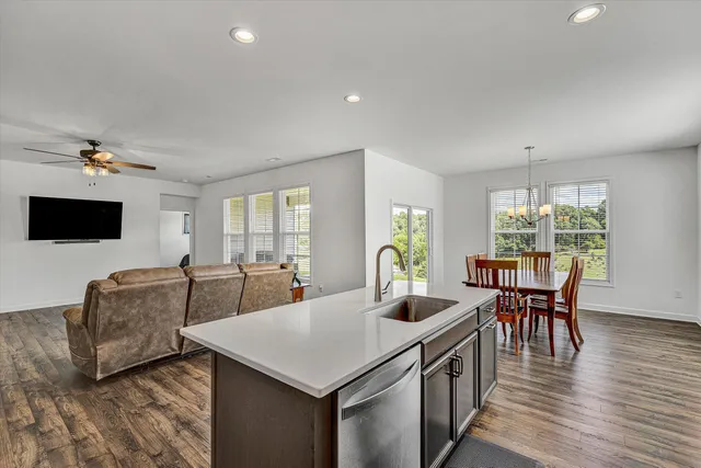 a view of a dining room with furniture wooden floor and chandelier
