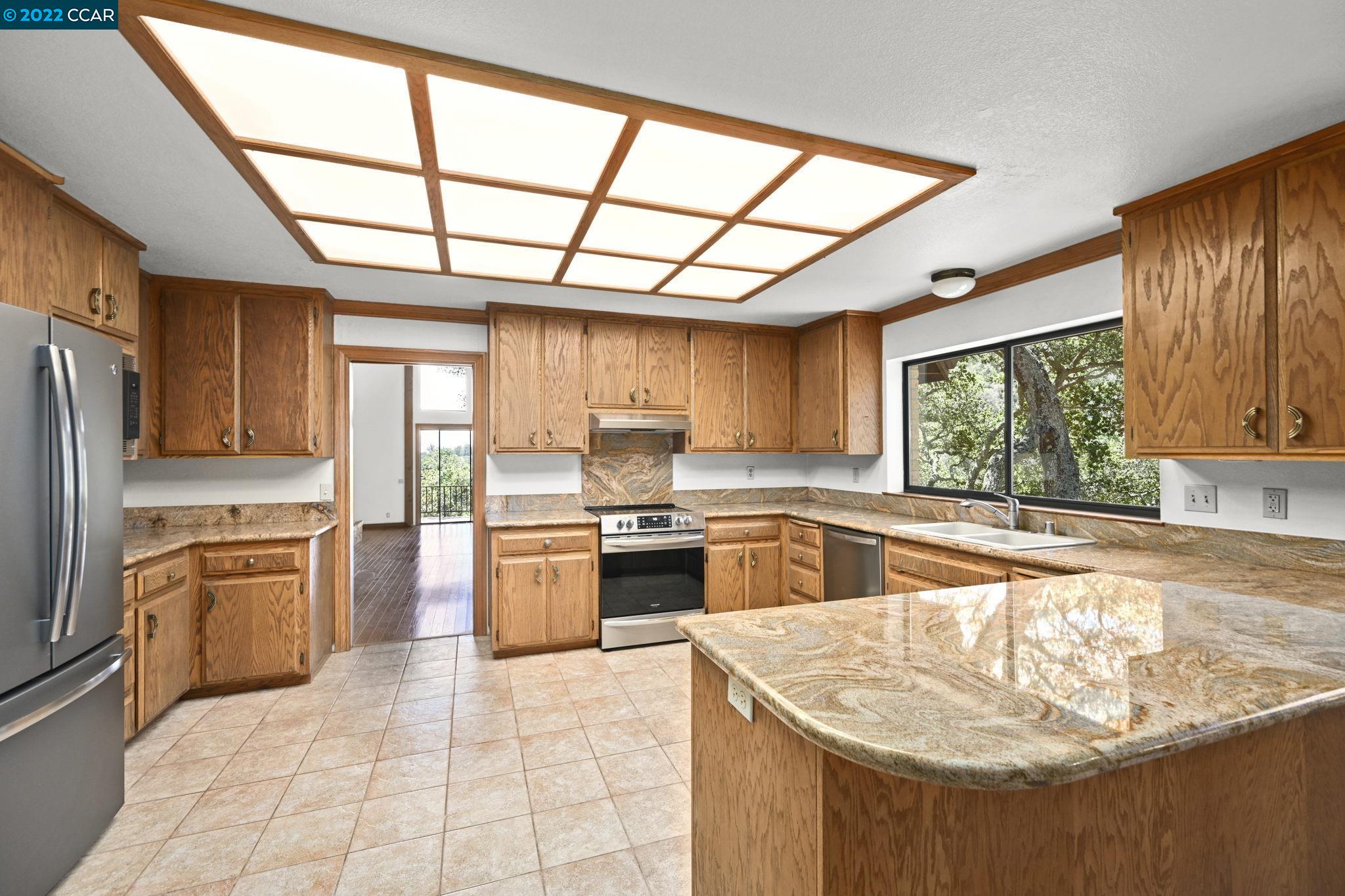 5433 Alhambra Valley Road Martinez, CA 94553 - Photo 14 of 59 a kitchen with stainless steel appliances granite countertop a stove a sink and a refrigerator