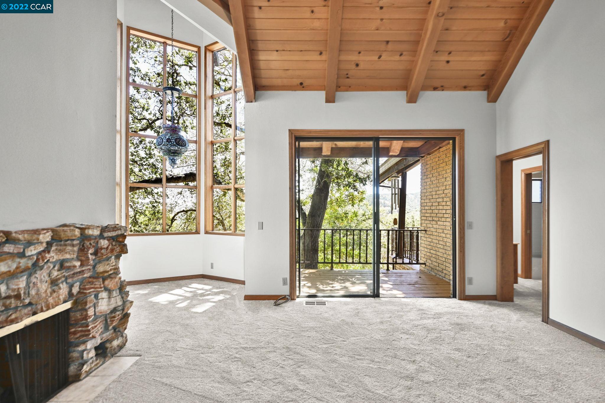 5433 Alhambra Valley Road Martinez, CA 94553 - Photo 20 of 59 a view of an empty room with a fireplace and a window