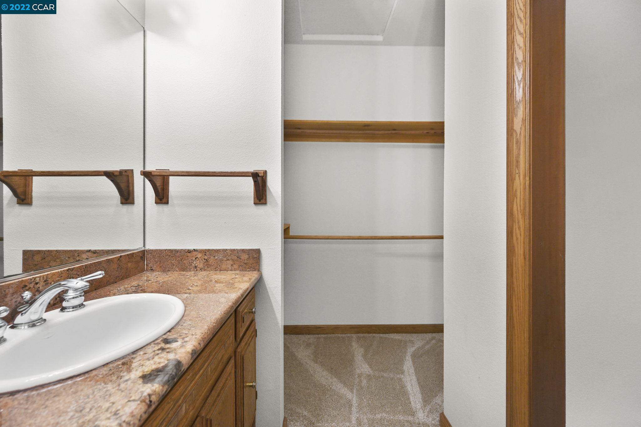 5433 Alhambra Valley Road Martinez, CA 94553 - Photo 23 of 59 a bathroom with a granite countertop sink and a mirror