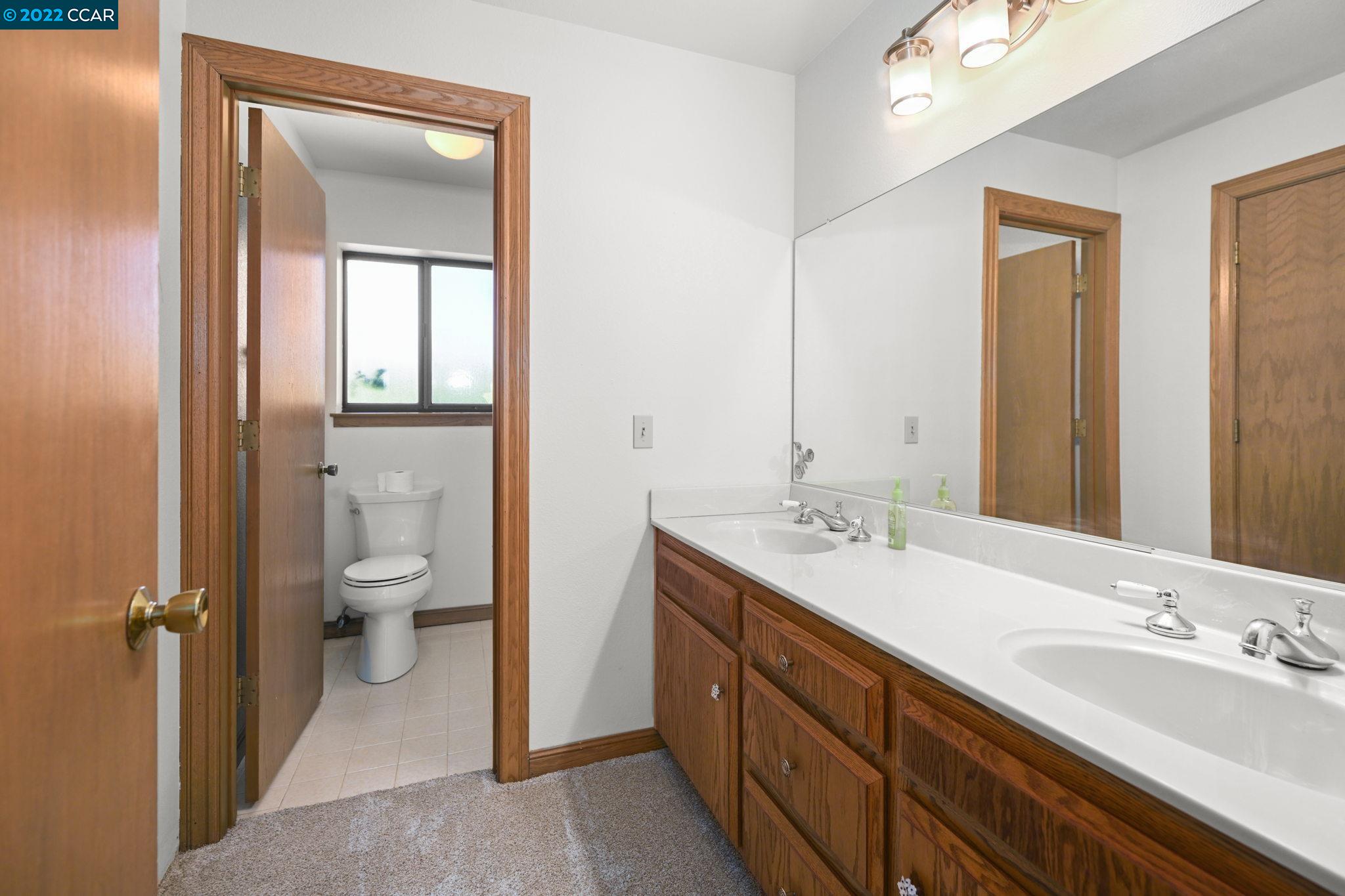 5433 Alhambra Valley Road Martinez, CA 94553 - Photo 25 of 59 a bathroom with a double vanity sink toilet mirror and shower