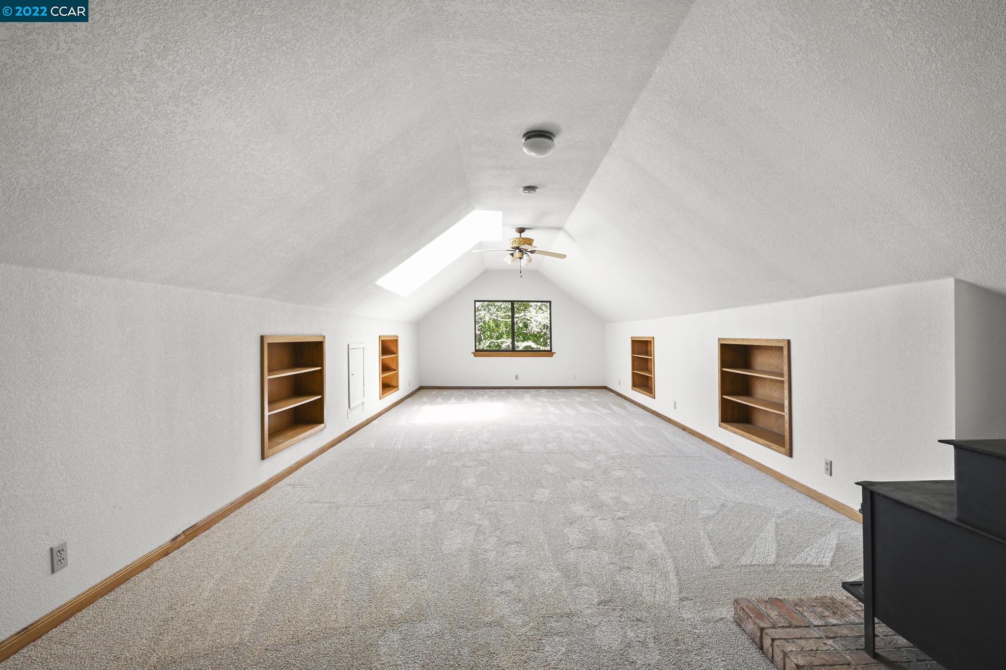 5433 Alhambra Valley Road Martinez, CA 94553 - Photo 29 of 59 a view of an empty room with a fireplace and a window