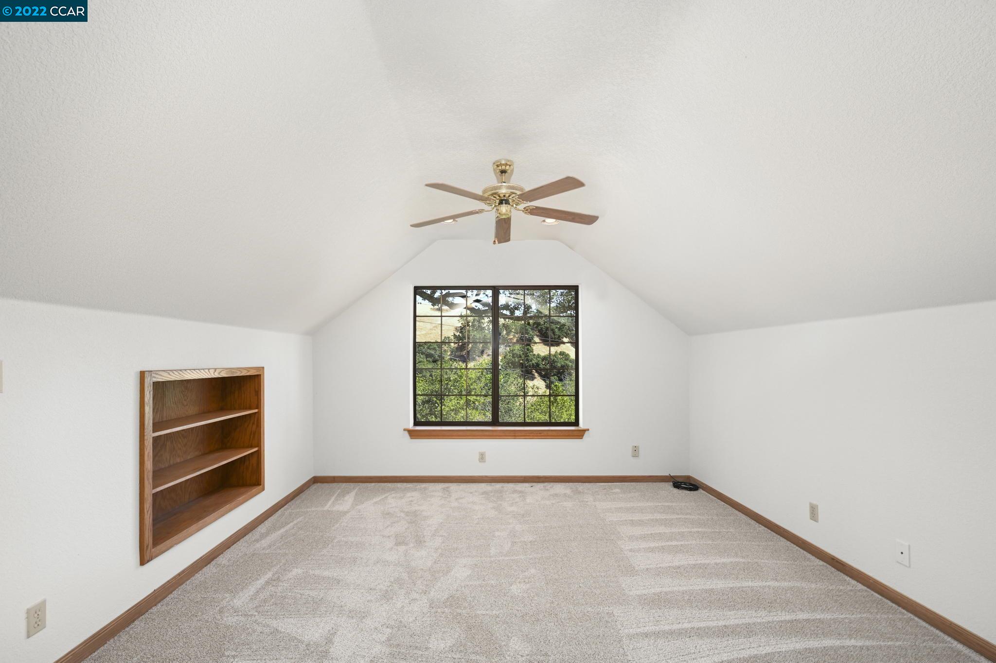 5433 Alhambra Valley Road Martinez, CA 94553 - Photo 33 of 59 an empty room with windows and ceiling fan