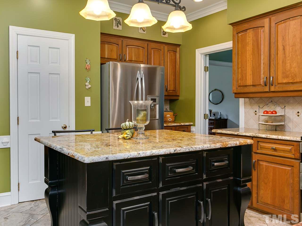 2004 Countrywood Road North Raleigh, NC 27615 - Photo 8 of 25 Gorgeous center island with loads of storage and shelves for cookbooks or ...