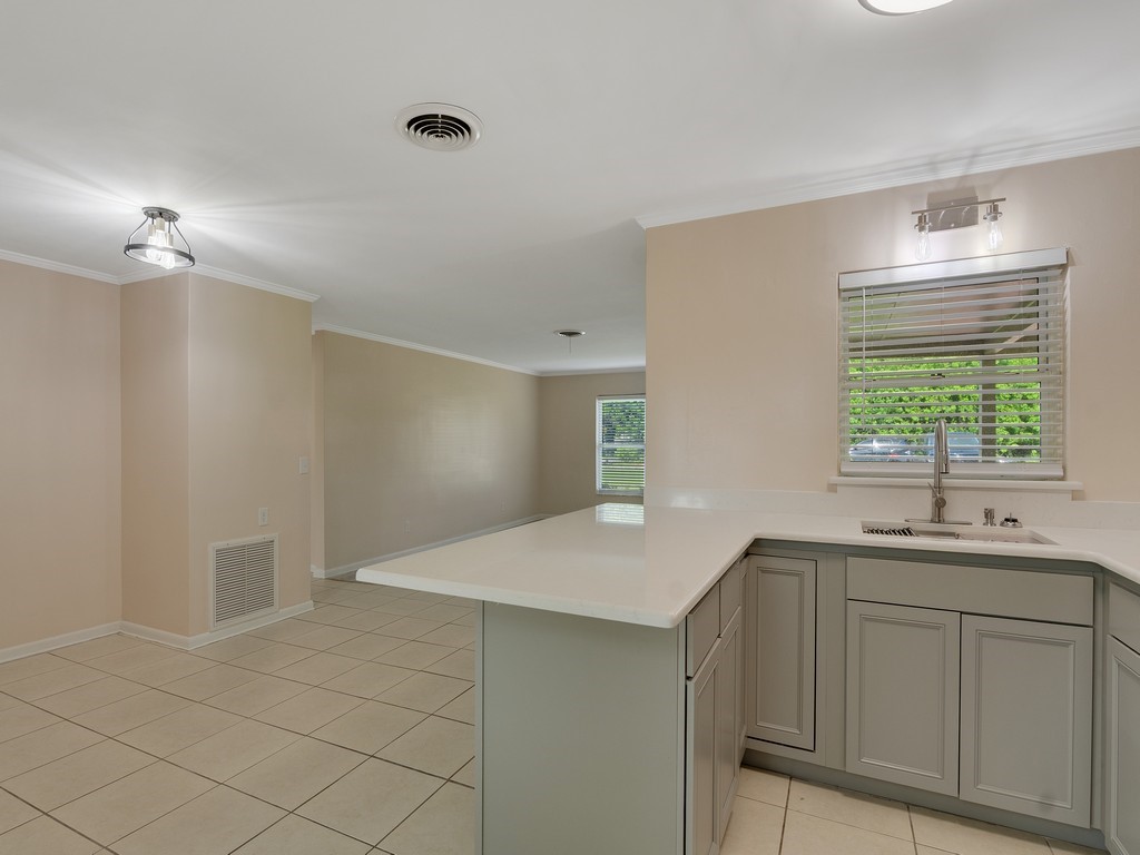 4606 30th Avenue Vero Beach, FL 32967 - Photo 15 of 33 a kitchen with a sink and cabinets