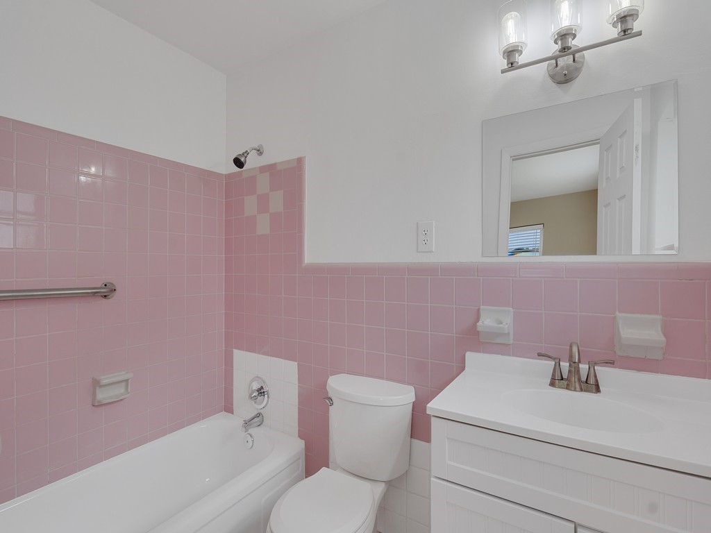 4606 30th Avenue Vero Beach, FL 32967 - Photo 28 of 33 a bathroom with a sink a toilet and a mirror