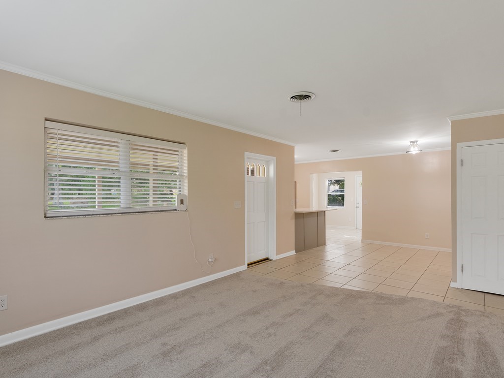 4606 30th Avenue Vero Beach, FL 32967 - Photo 7 of 33 a view of an empty room with wooden floor and a window