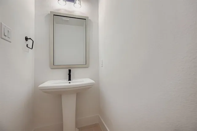 a view of a room with a window and wooden floor