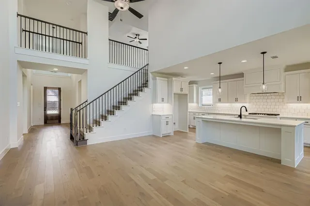 a view of a kitchen with wooden floor and electronic appliances