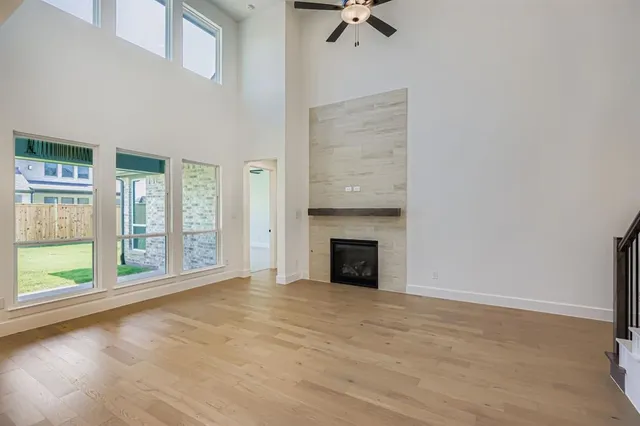 a view of an empty room with a fireplace and a window