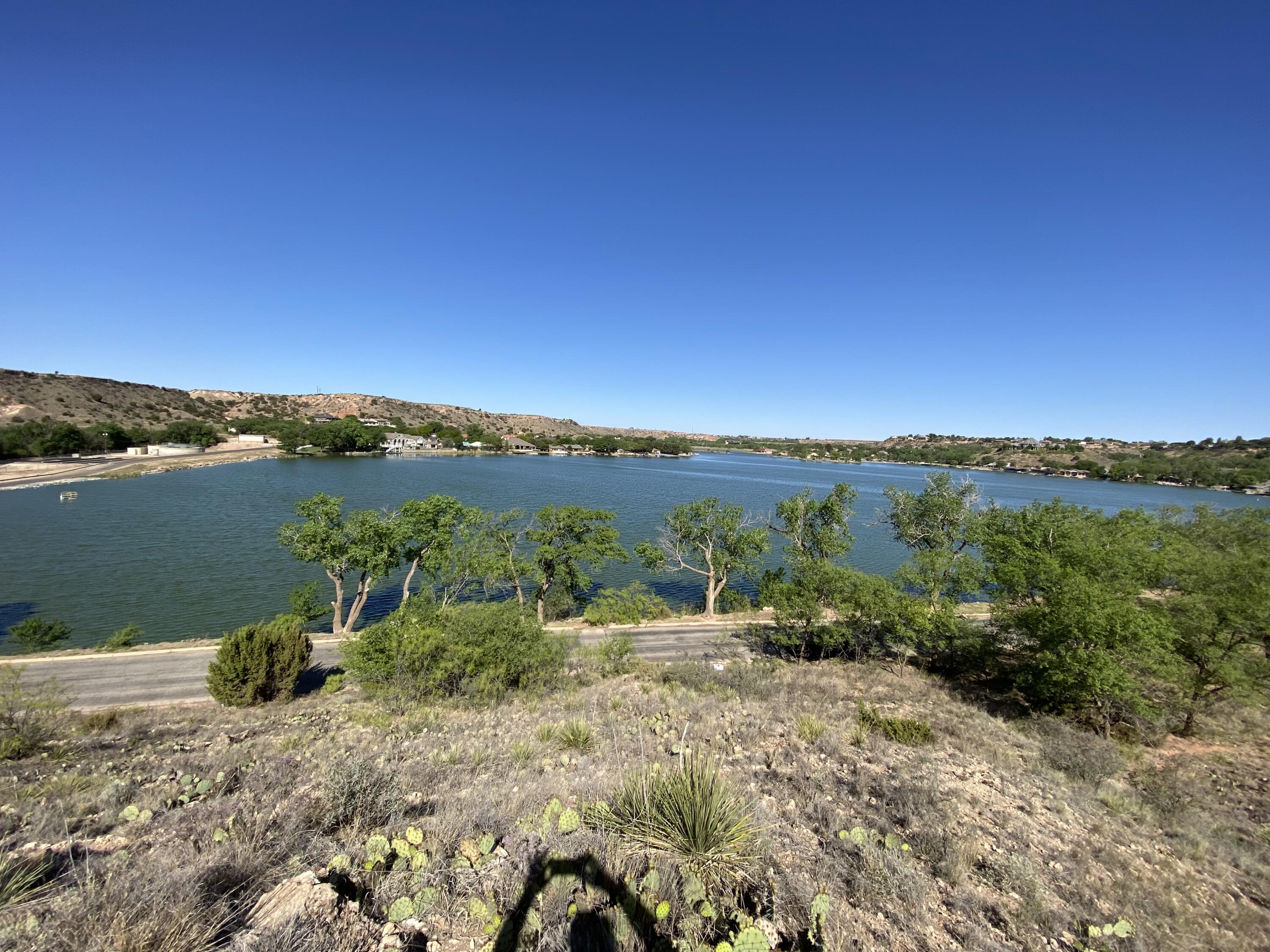 76 East Lakeshore Drive Ransom Canyon, TX 79366 - Photo 2 of 6 a view of a lake with mountains in the background