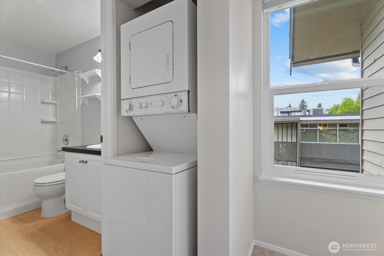 1109 North Allen Place, Unit 205 Seattle, WA 98103 - Photo 12 of 26 a bathroom with a sink a toilet and a mirror