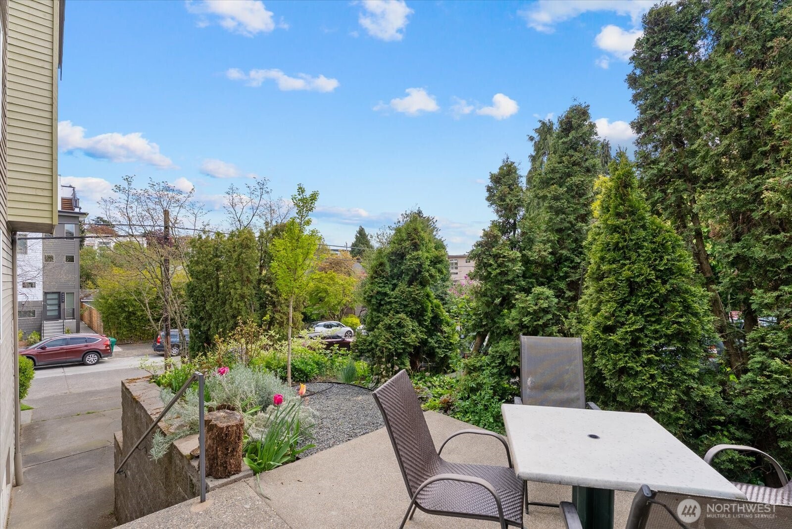 1109 North Allen Place, Unit 205 Seattle, WA 98103 - Photo 4 of 26 a view of a patio with table and chairs and potted plants