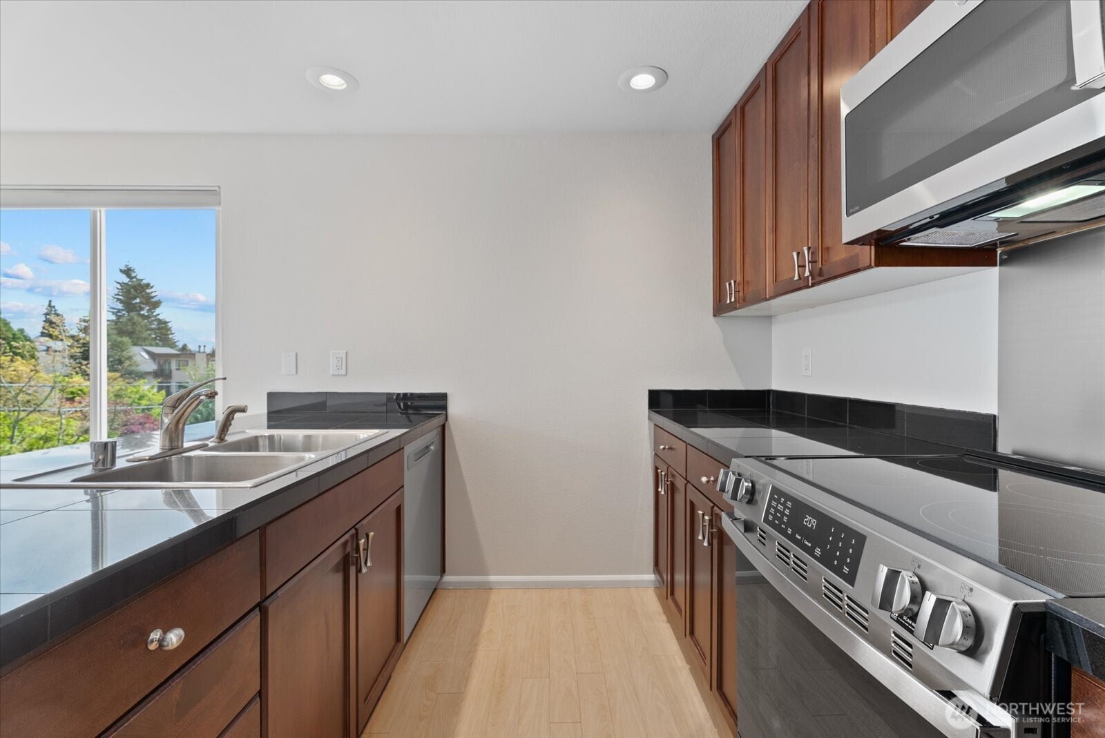 1109 North Allen Place, Unit 205 Seattle, WA 98103 - Photo 5 of 26 a kitchen with a stove and a sink