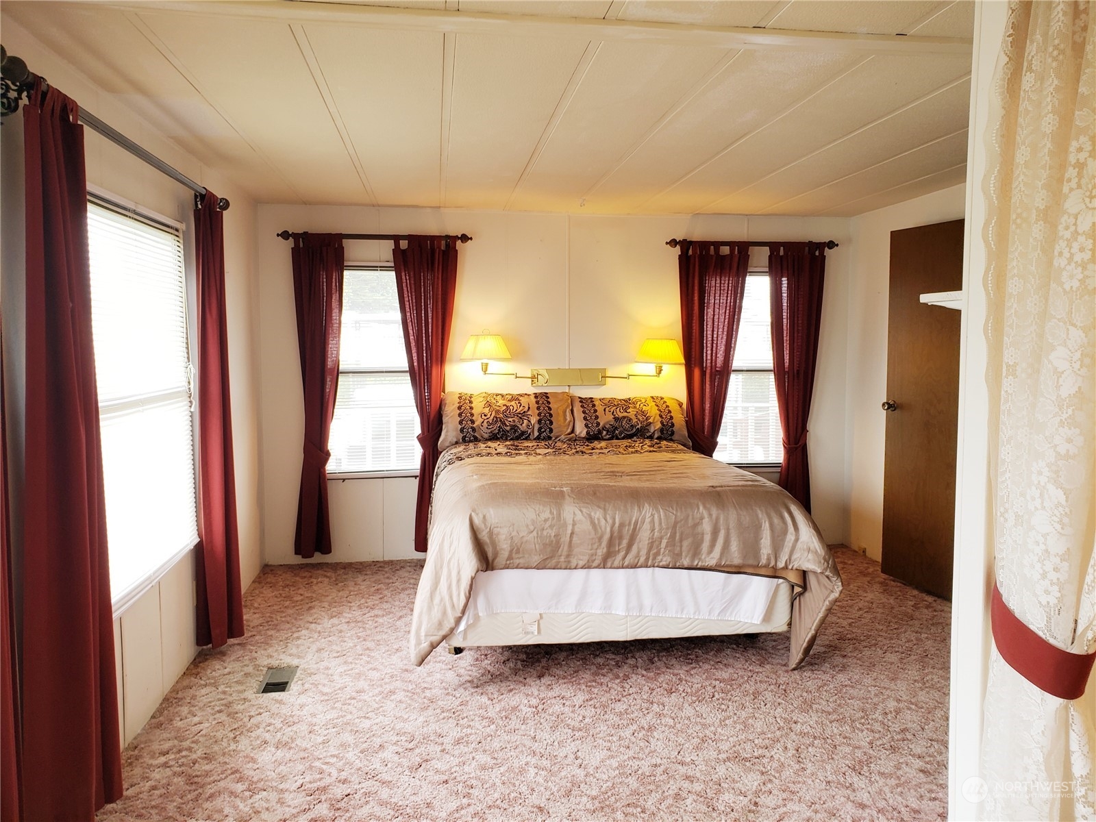 1080 Pine Drive Enumclaw, WA 98022 - Photo 18 of 36 a spacious bedroom with a bed and large windows