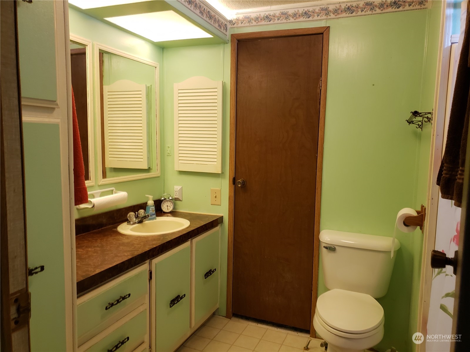1080 Pine Drive Enumclaw, WA 98022 - Photo 28 of 36 a bathroom with a granite countertop sink toilet and mirror