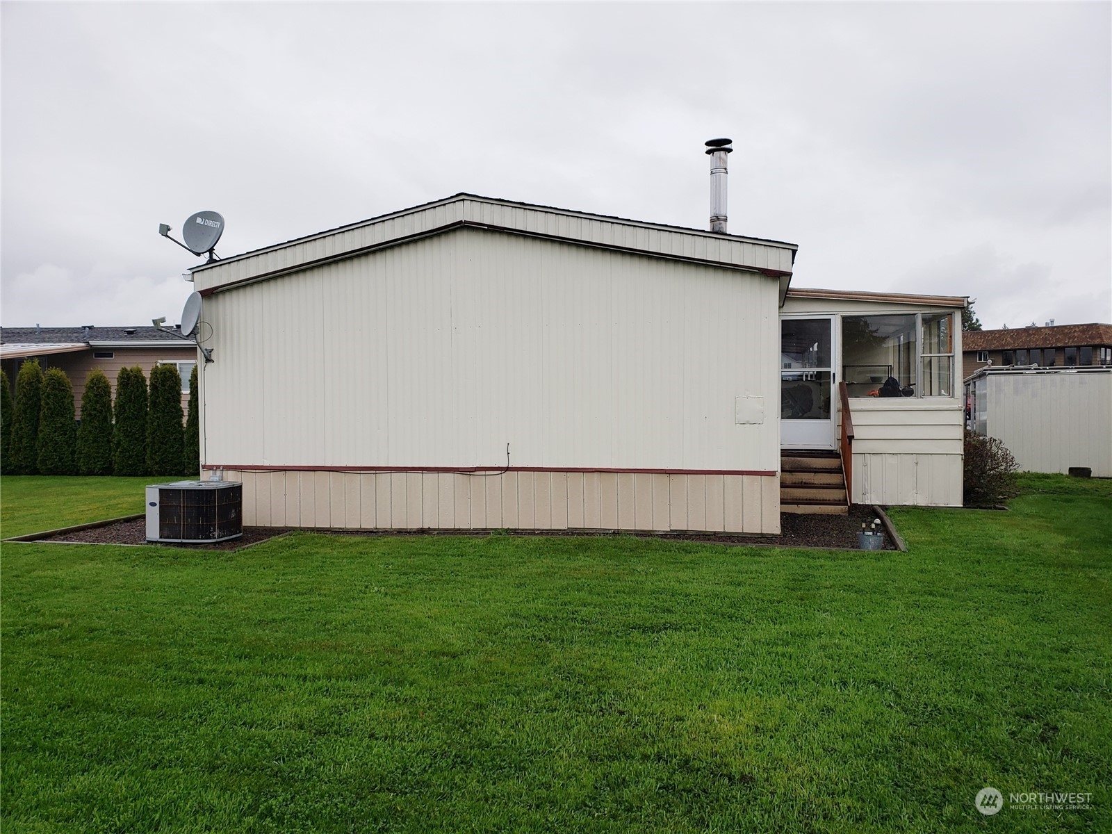 1080 Pine Drive Enumclaw, WA 98022 - Photo 35 of 36 a backyard of a house with lots of green space and plants