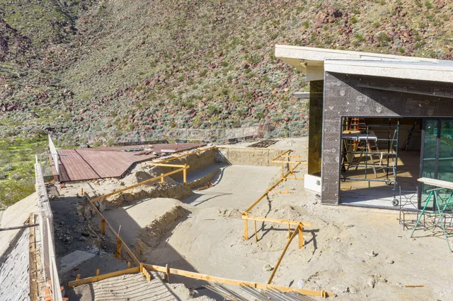 a roof deck with table and chairs