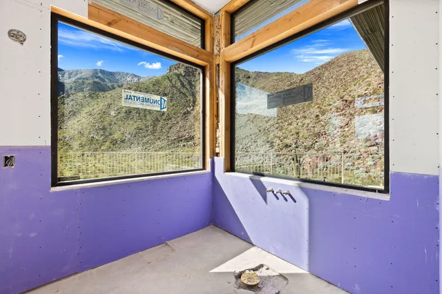 an empty room with windows and closet