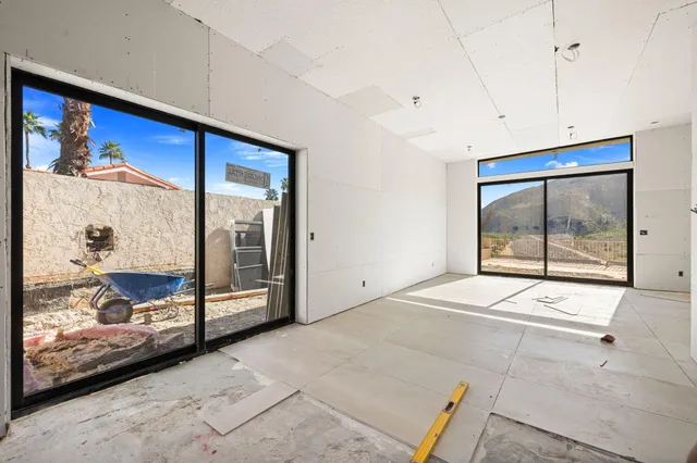 a spacious bedroom with a large bed and a large window
