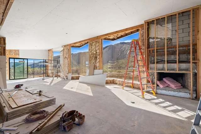 a living room with furniture gym equipment and large windows