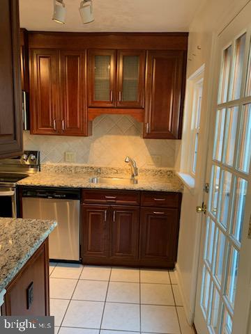 3452 South Utah Street, Unit A Arlington, VA 22206 - Photo 5 of 15 a kitchen with stainless steel appliances granite countertop wooden cabinets a sink and dishwasher
