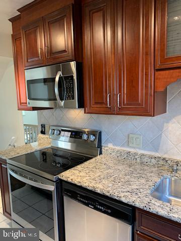 3452 South Utah Street, Unit A Arlington, VA 22206 - Photo 6 of 15 a kitchen with granite countertop stainless steel appliances window a sink and cabinets