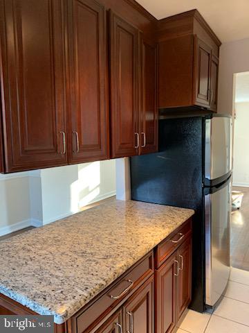 3452 South Utah Street, Unit A Arlington, VA 22206 - Photo 7 of 15 a kitchen with granite countertop cabinets and refrigerator