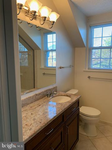 3452 South Utah Street, Unit A Arlington, VA 22206 - Photo 8 of 15 a bathroom with a granite countertop sink a toilet and a window