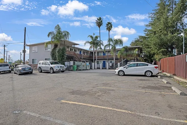 a view of a cars park in front of a building
