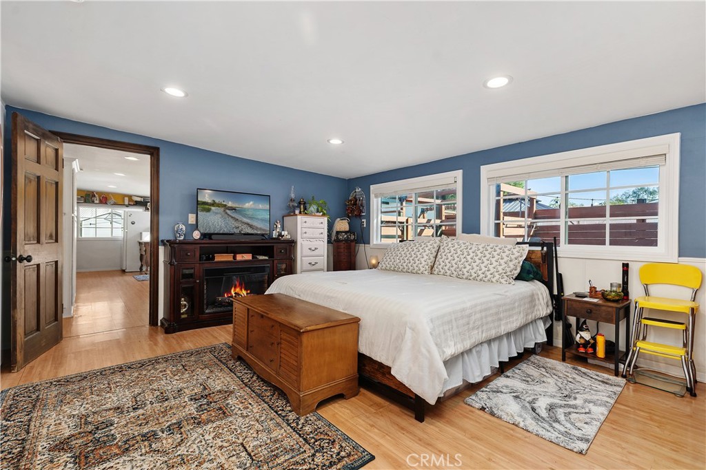 20292 Riverside Drive Newport Beach, CA 92660 - Photo 19 of 23 a spacious bedroom with a bed a table and large windows